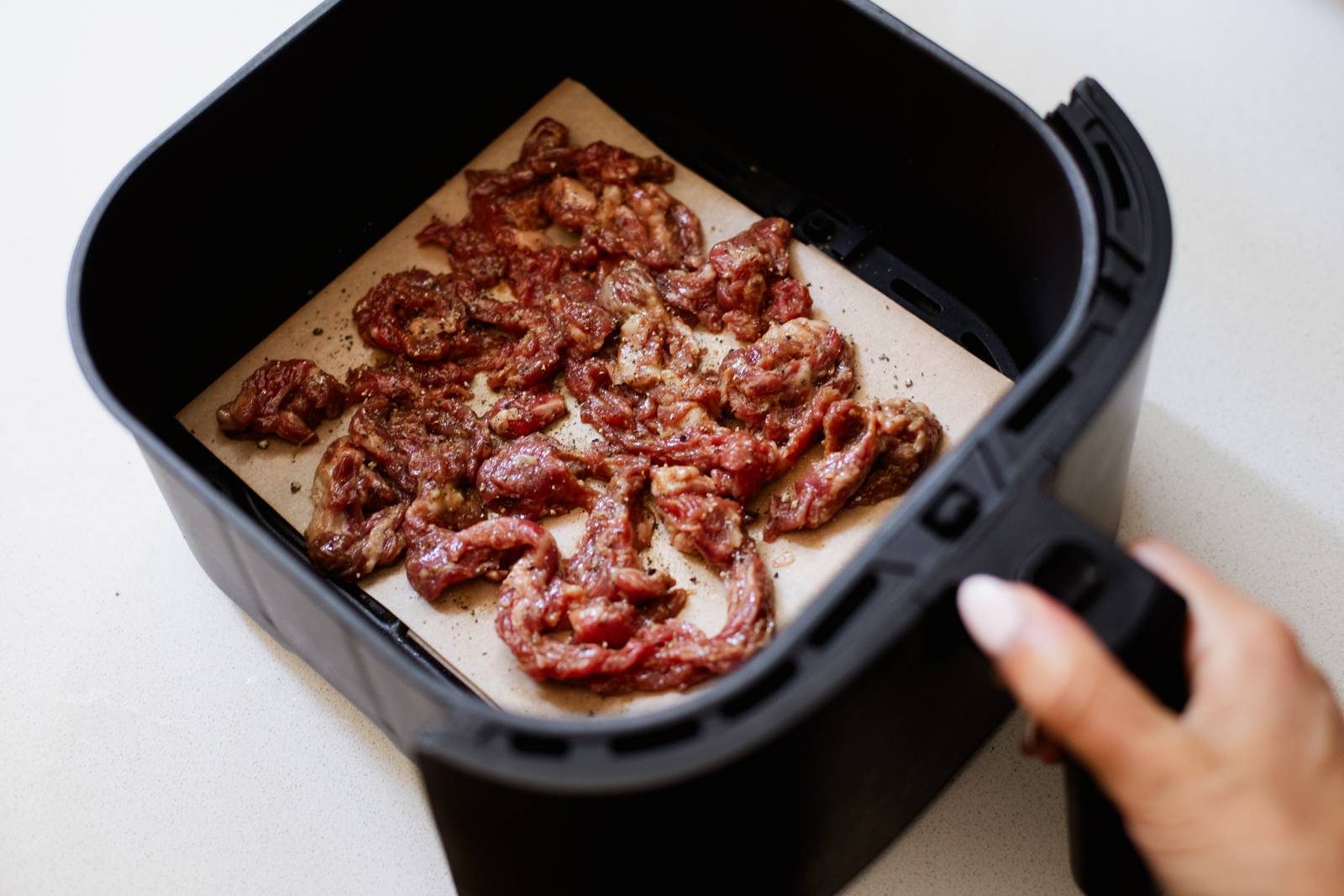 Steak strips in an air fryer.
