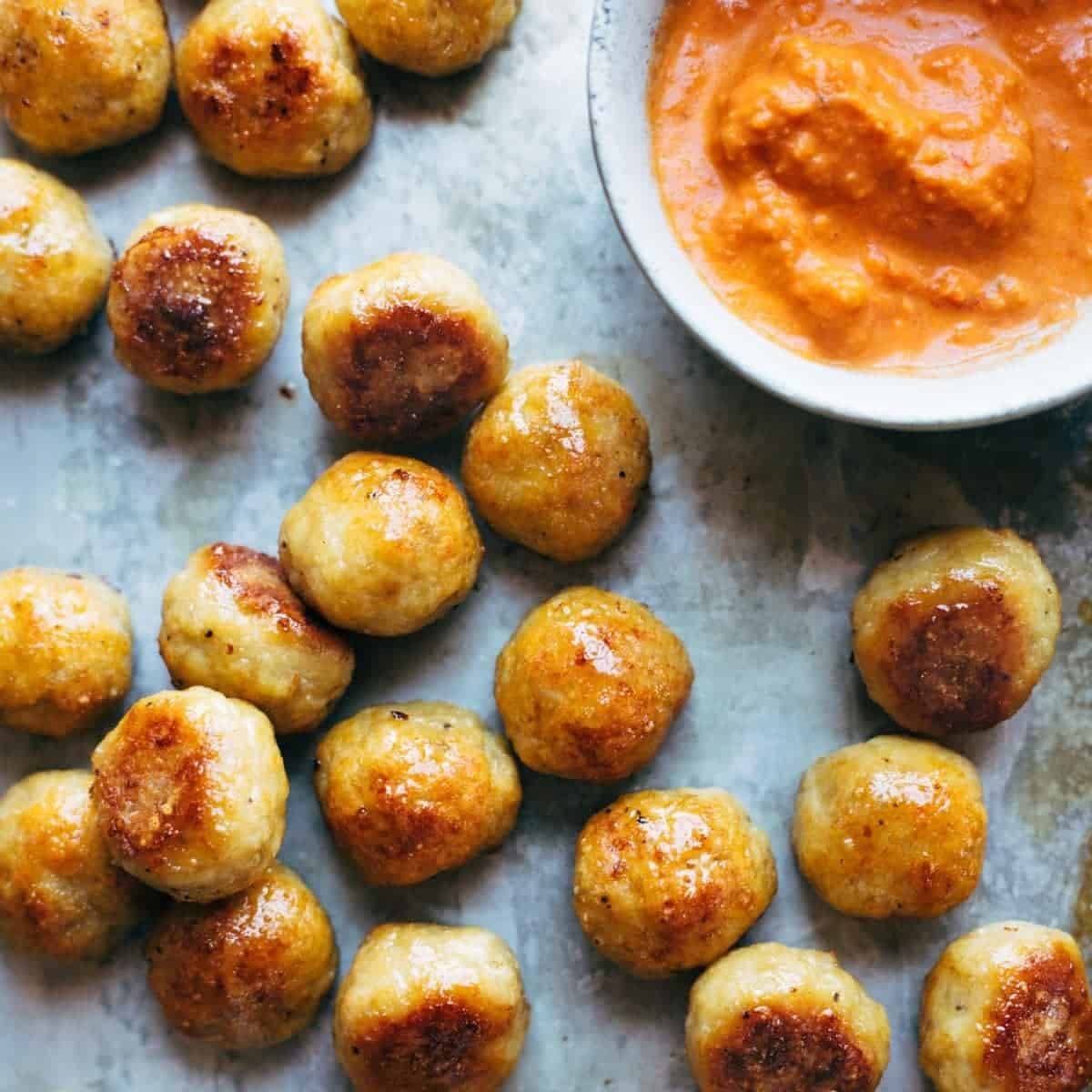 Chicken meatballs with romesco sauce.