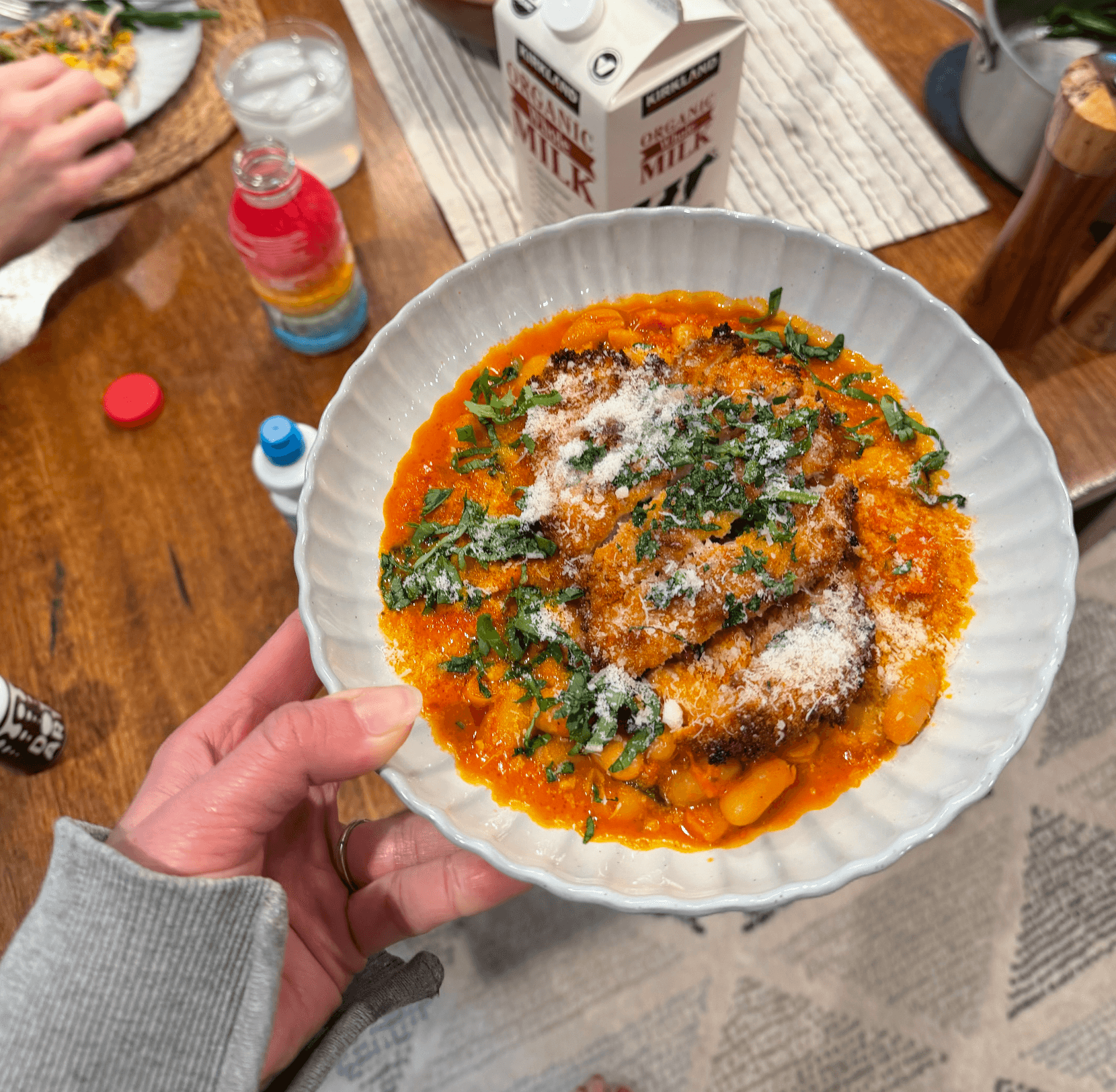 Garlic Butter Crispy Chicken with Creamy Beans over a dinner table