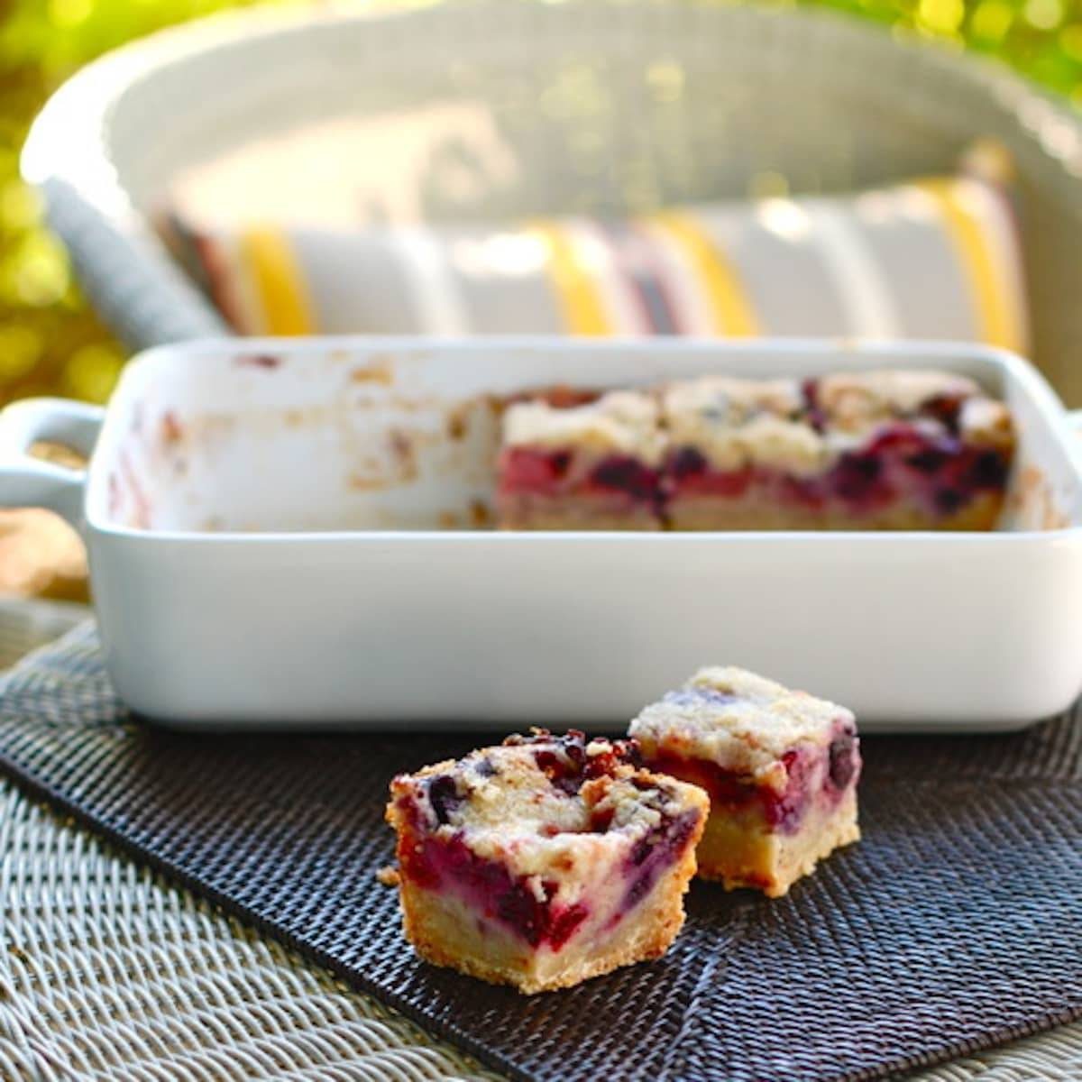 Triple berry pie bars in white baking dish.