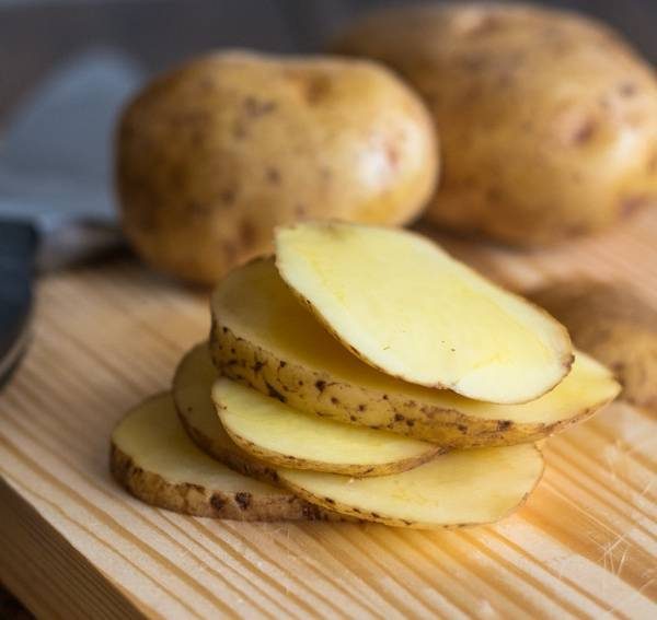 Crispy Potato Mojos sliced on a cutting board.